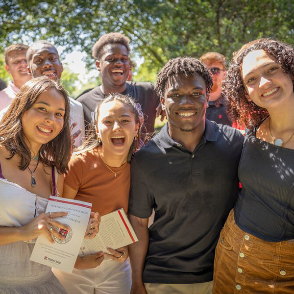 a group of young students smile at the camera