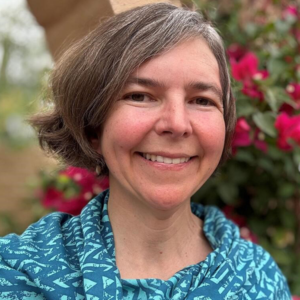 a woman with short, graying hair smiles at the camera