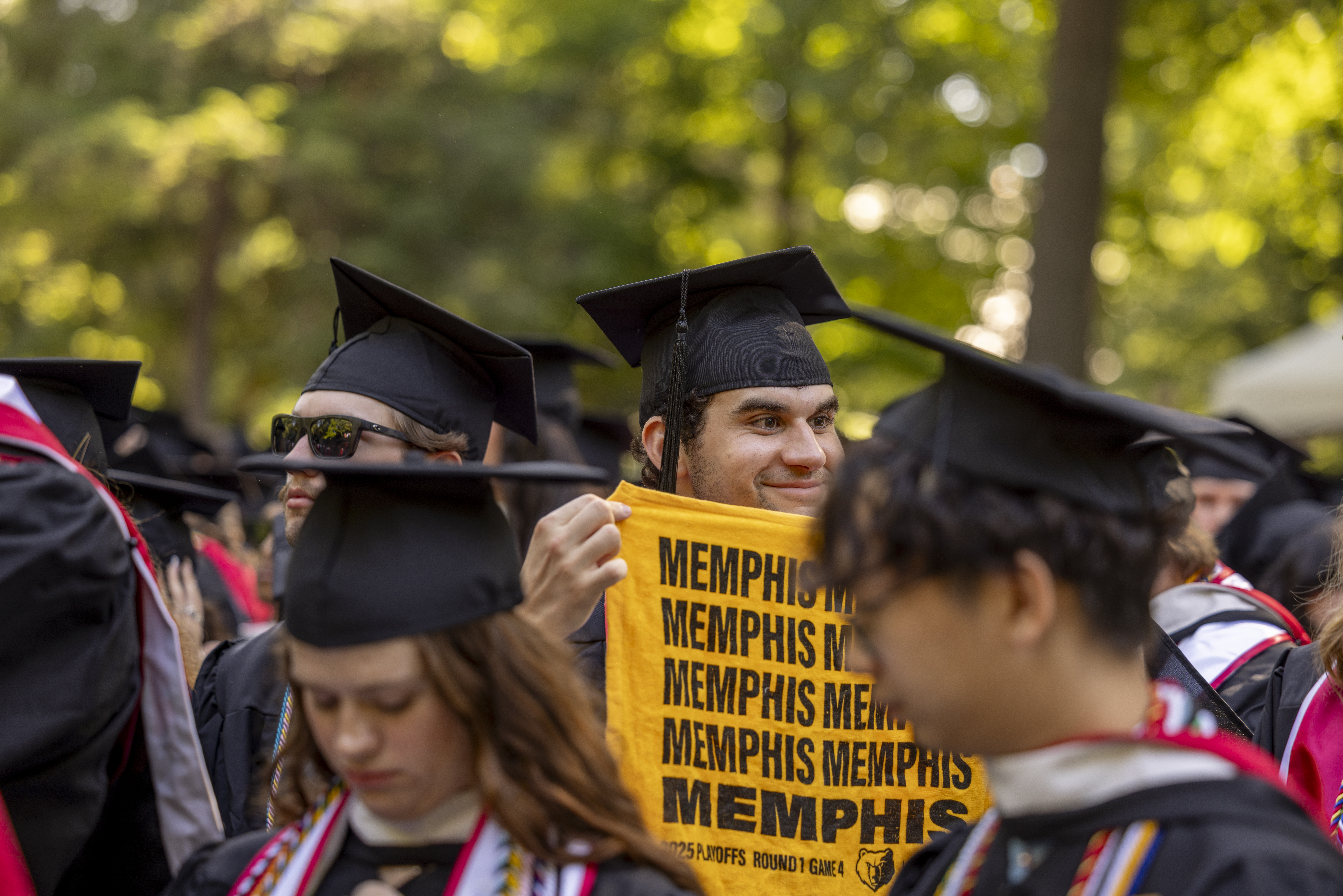 Graduate holding Memphis sign