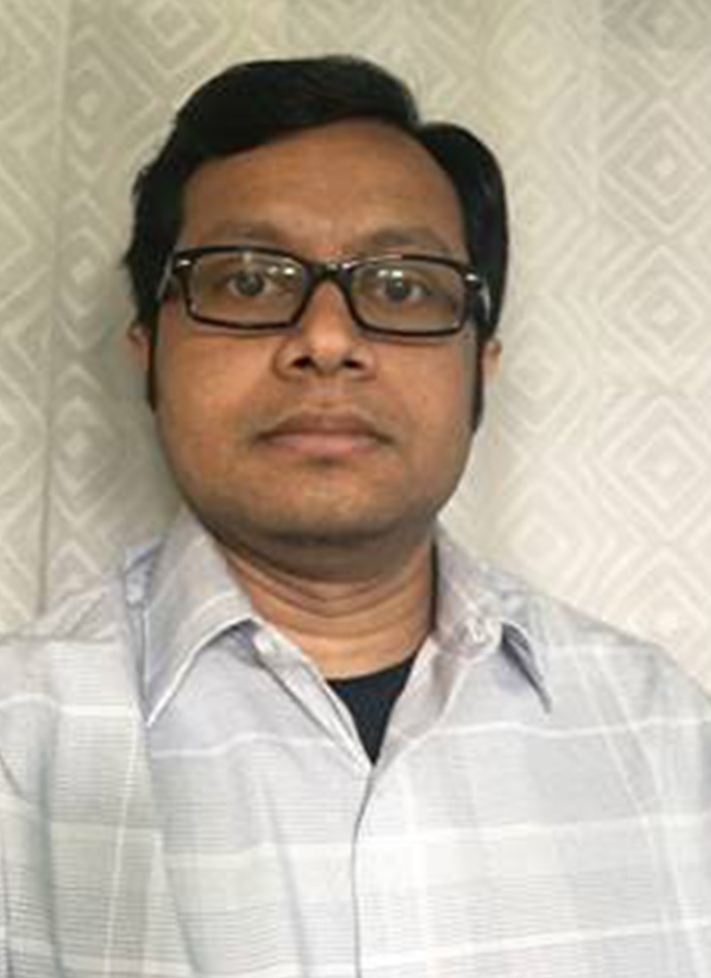 a man with dark hair and glasses 