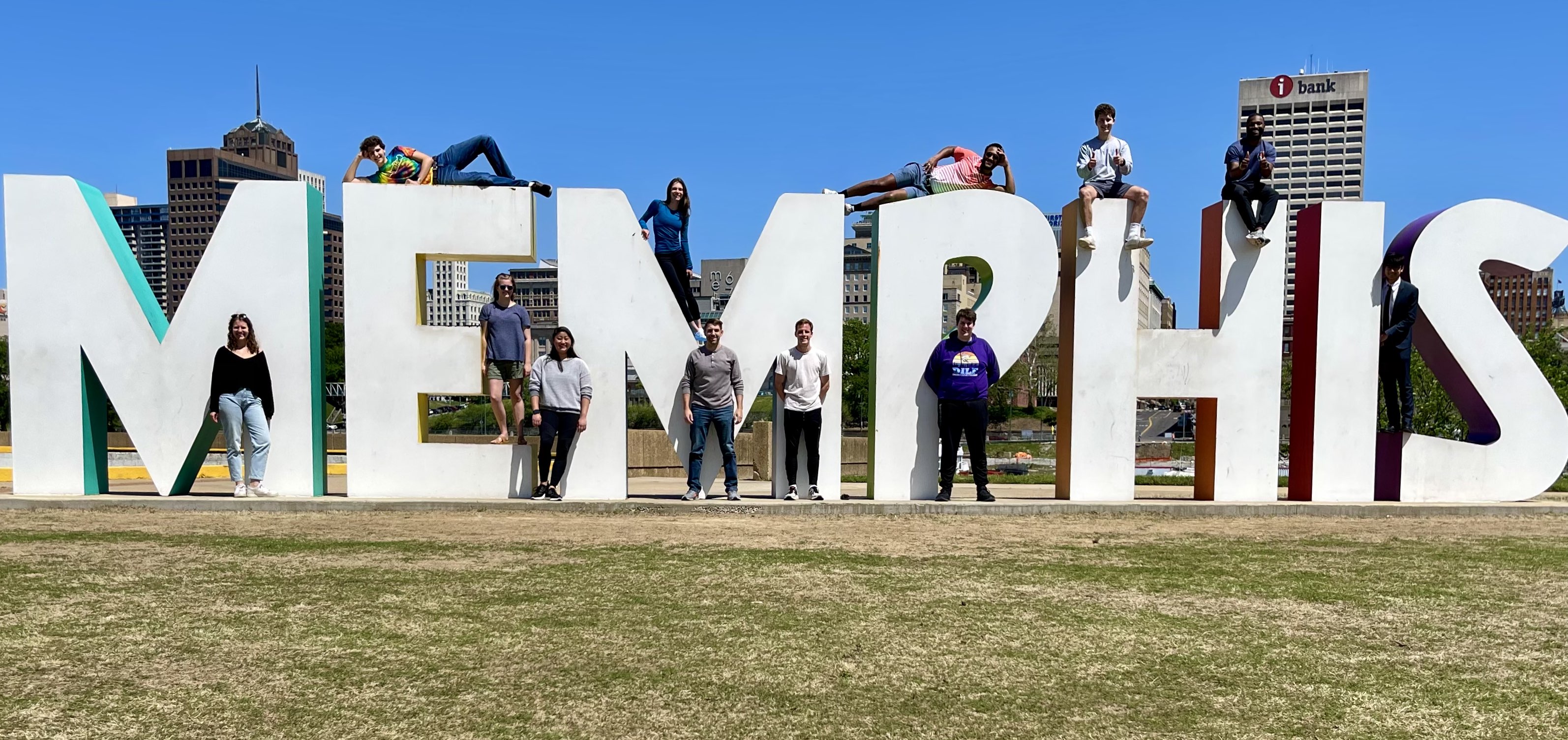 students pose with large block letters that spell out Memphis