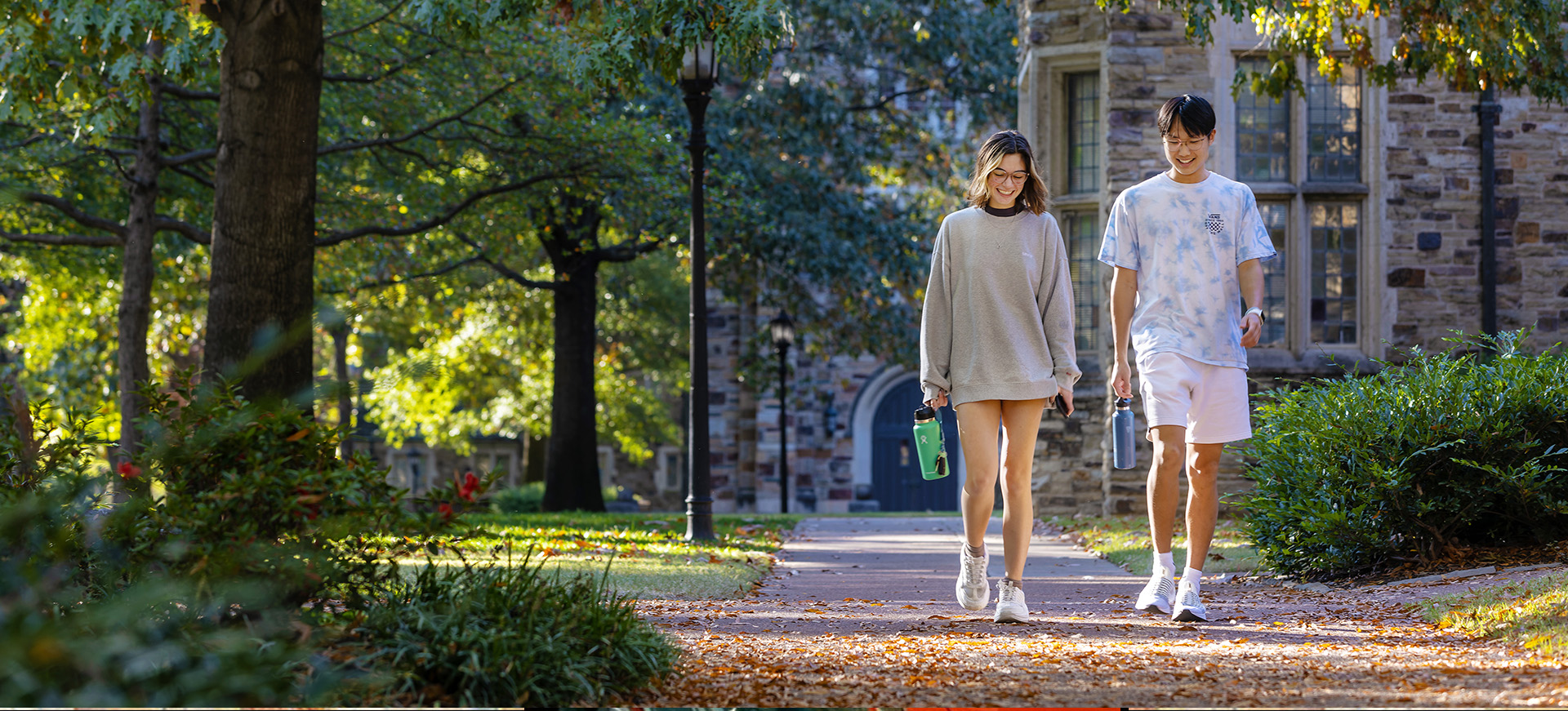 two students walk across campus