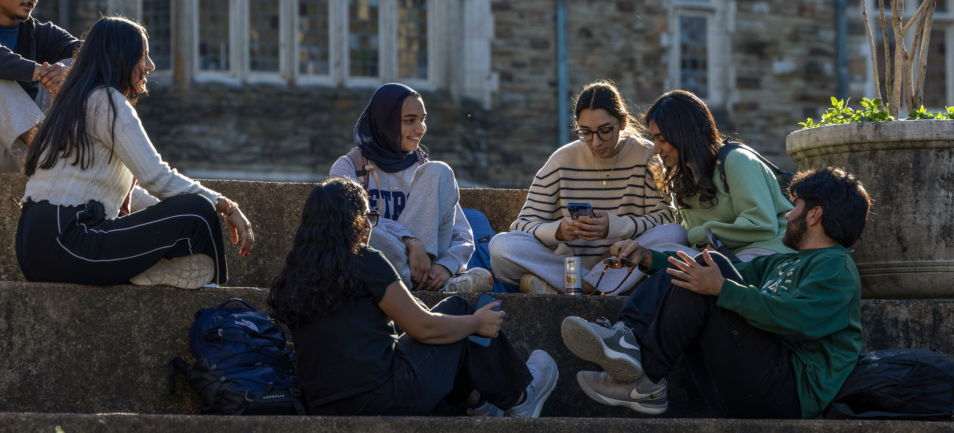 students gather to talk on the amphitheater steps