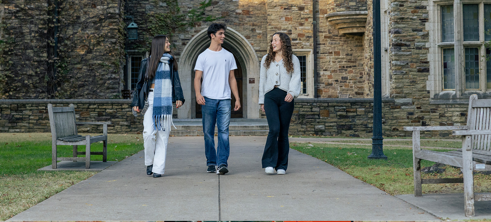 three students walk on campus