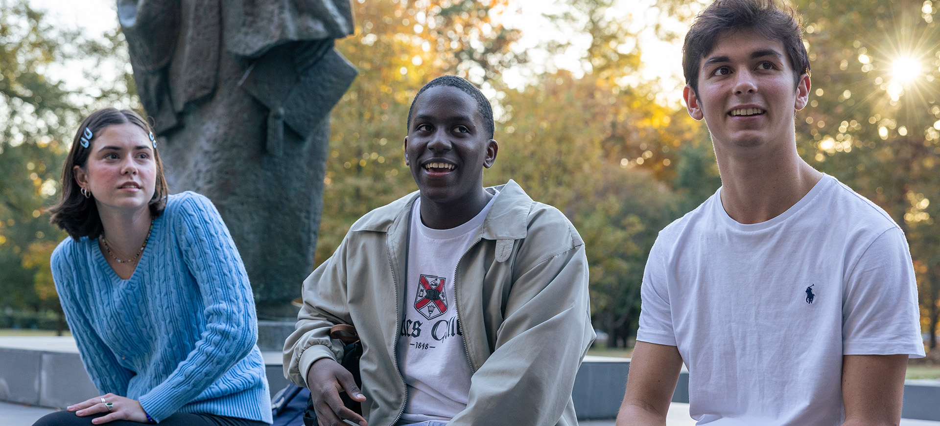 a female and two male students talk