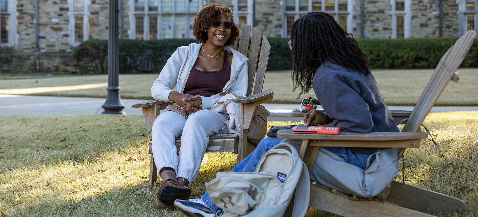 two students chat in the quad