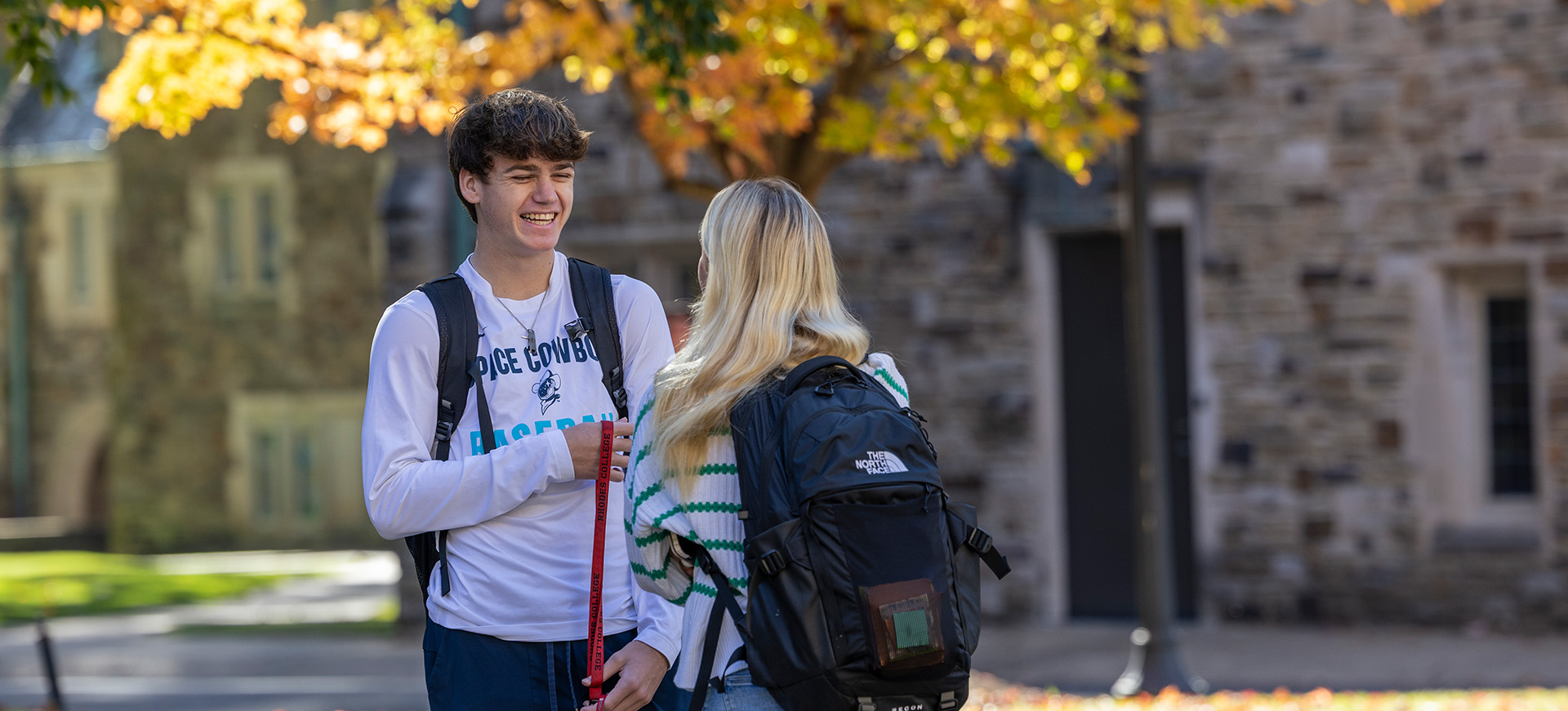 two students talking in front of a Gothic building