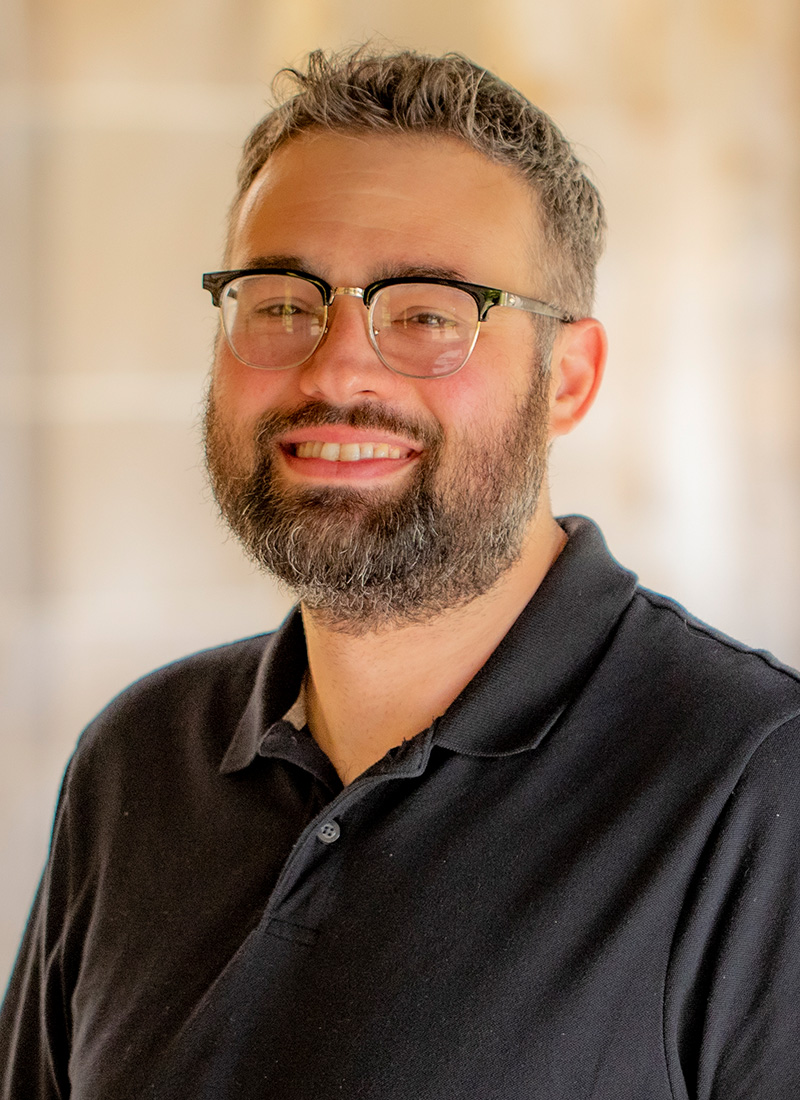 a man with a beard and glasses