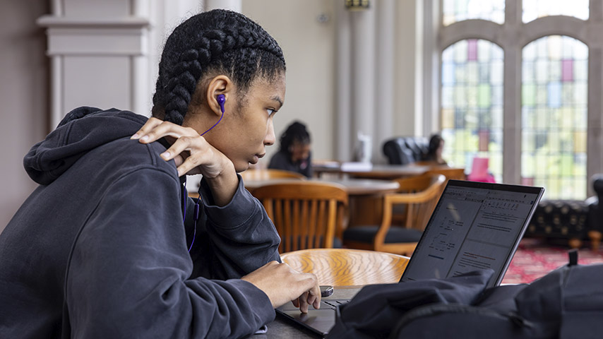 a student looks ata laptop