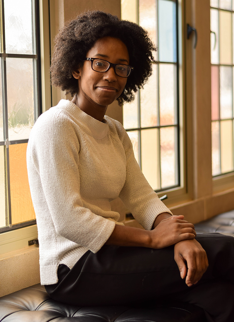Shana Stoddard sitting in front of stained glass windows