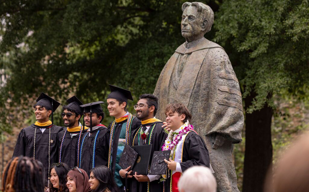 students in front of statue