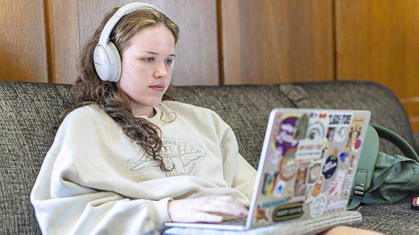 a young woman works on a laptop