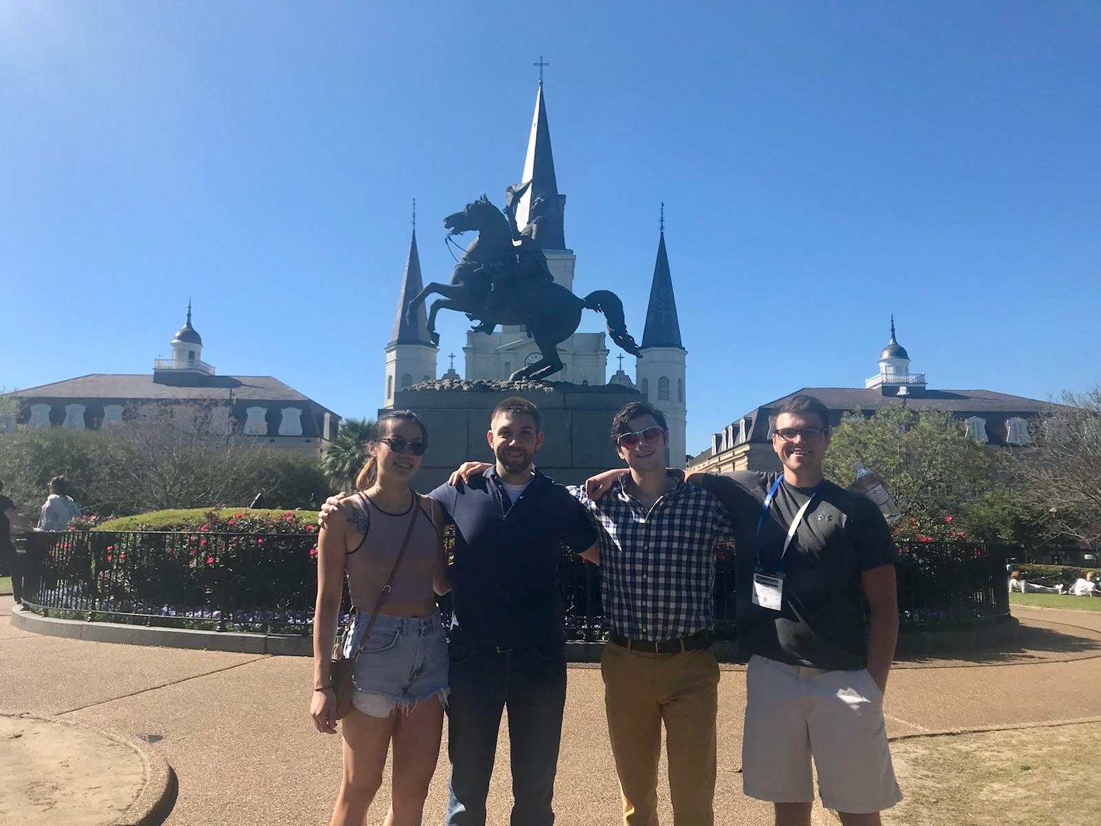 two female and two male student in front of a statue in New Orleans