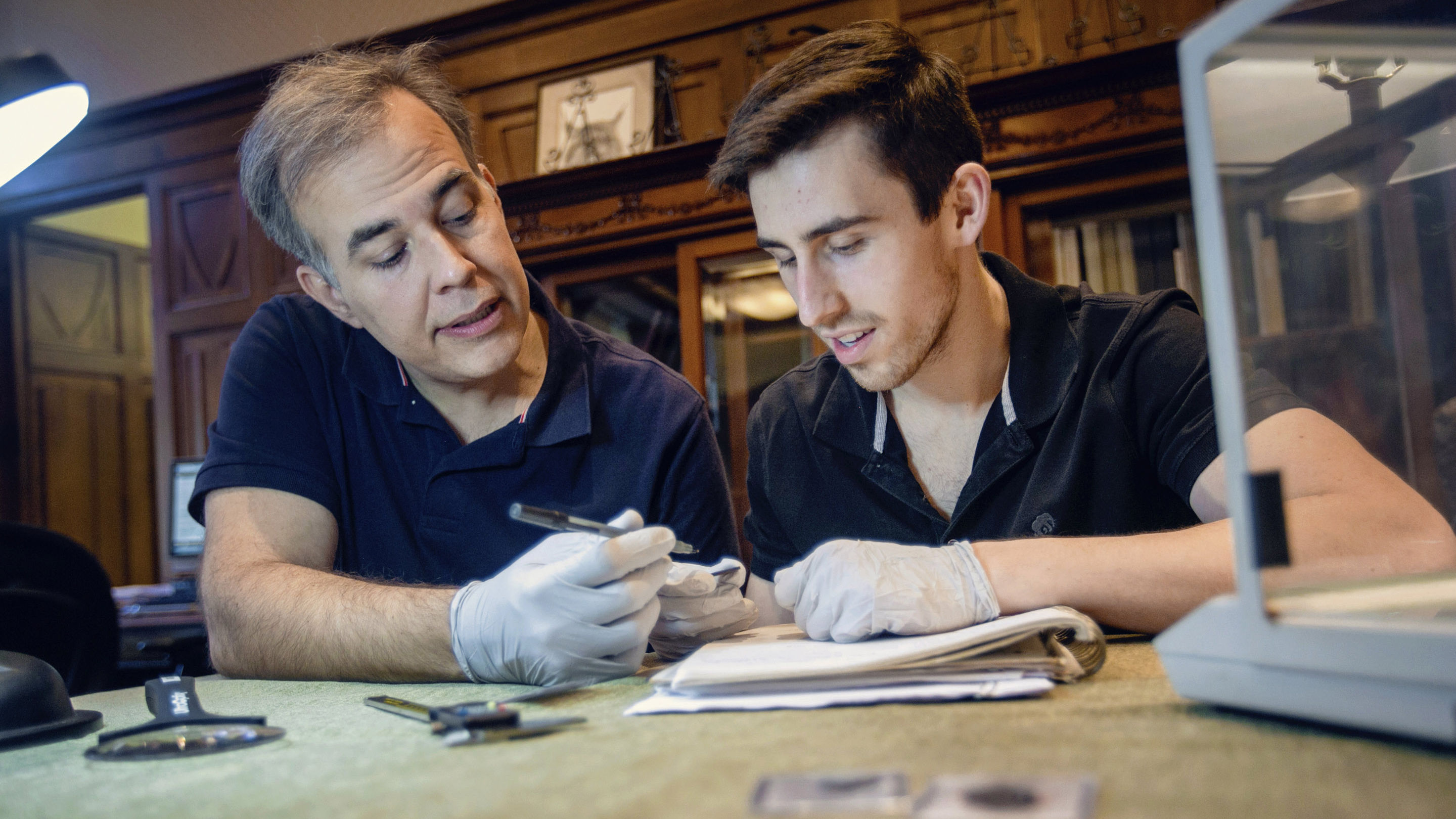 a professor and a student examining an artifact