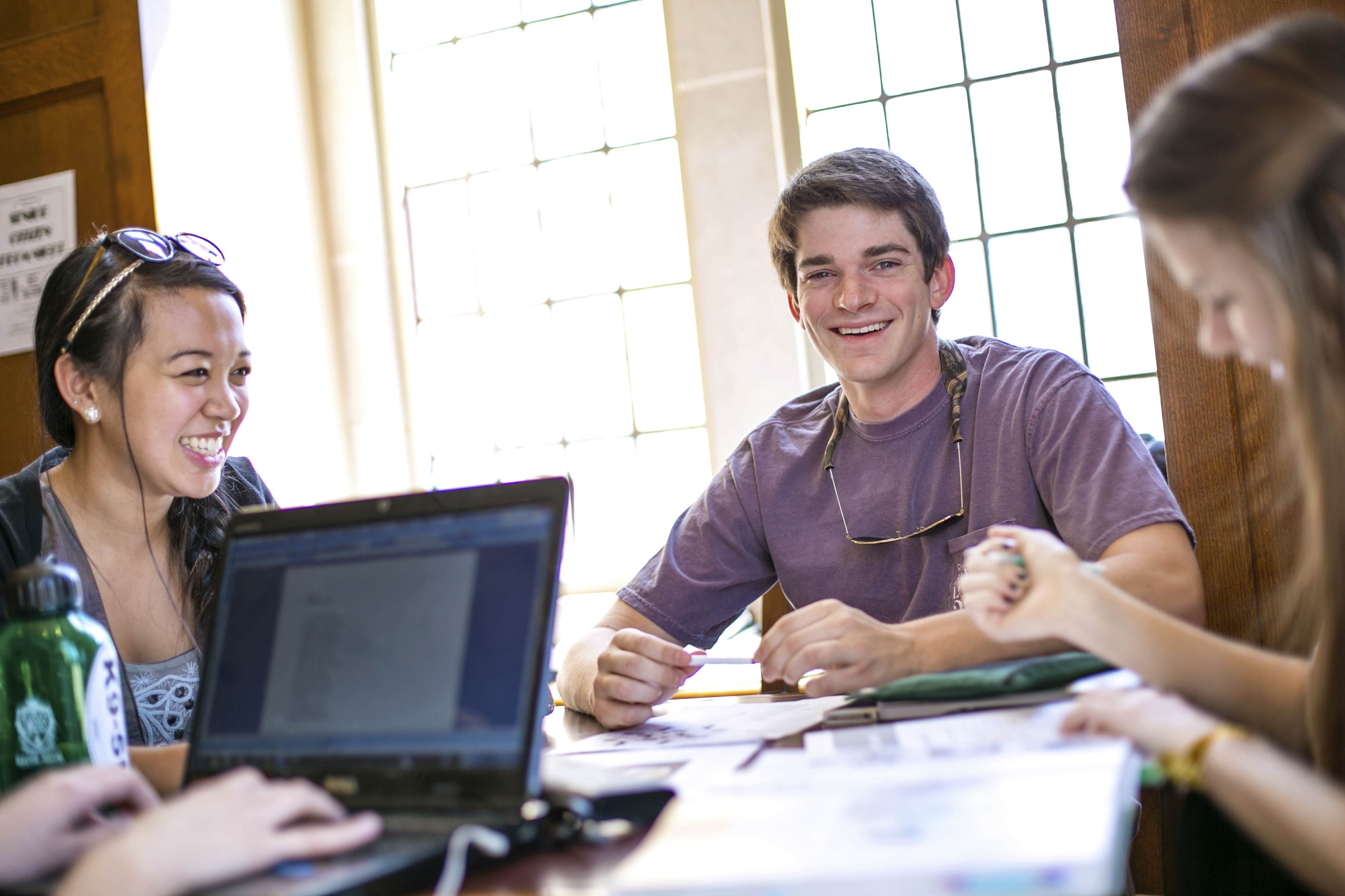 a group of students talking around a table