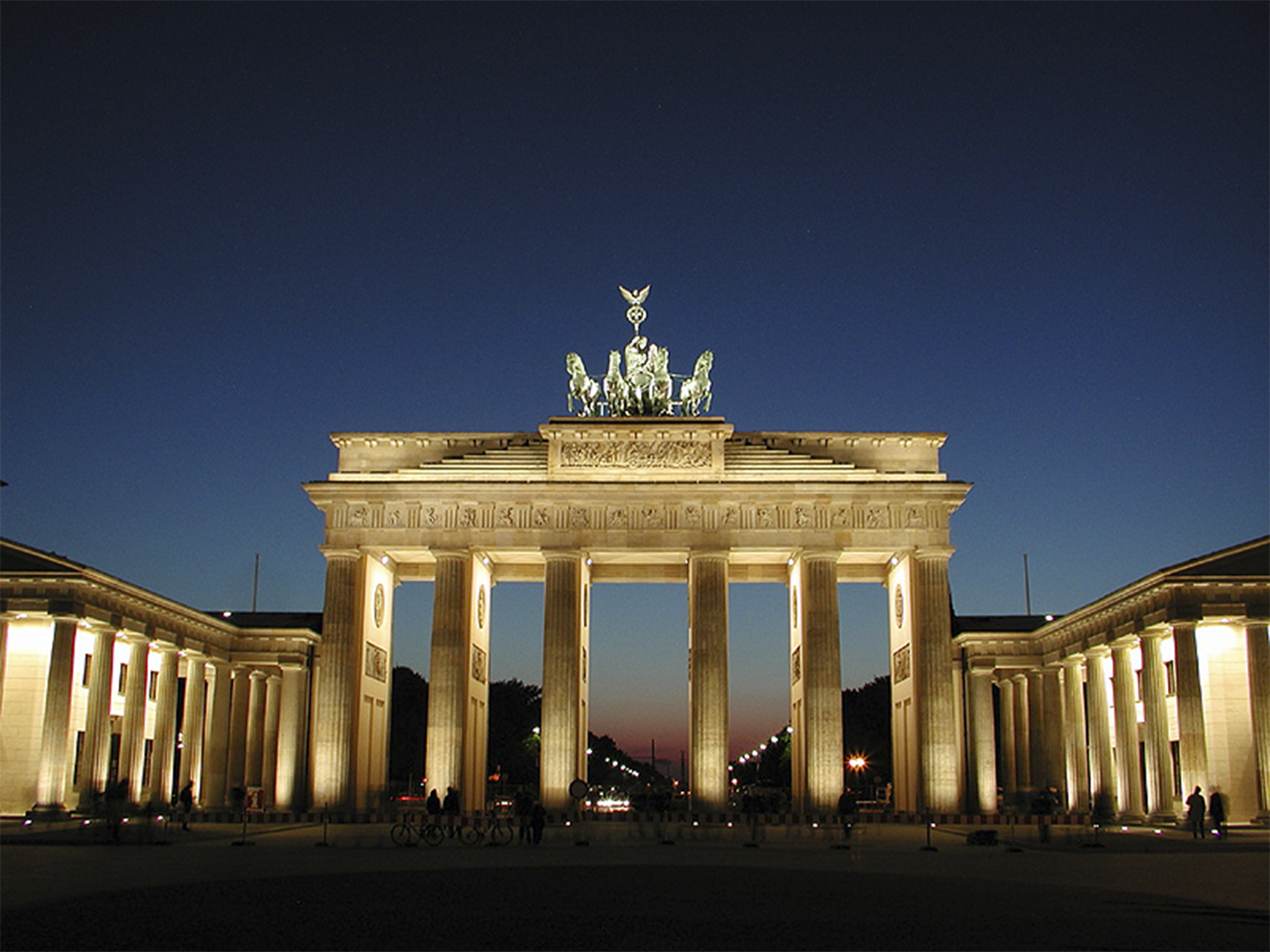 Tall arch with multiple columns lighted at night