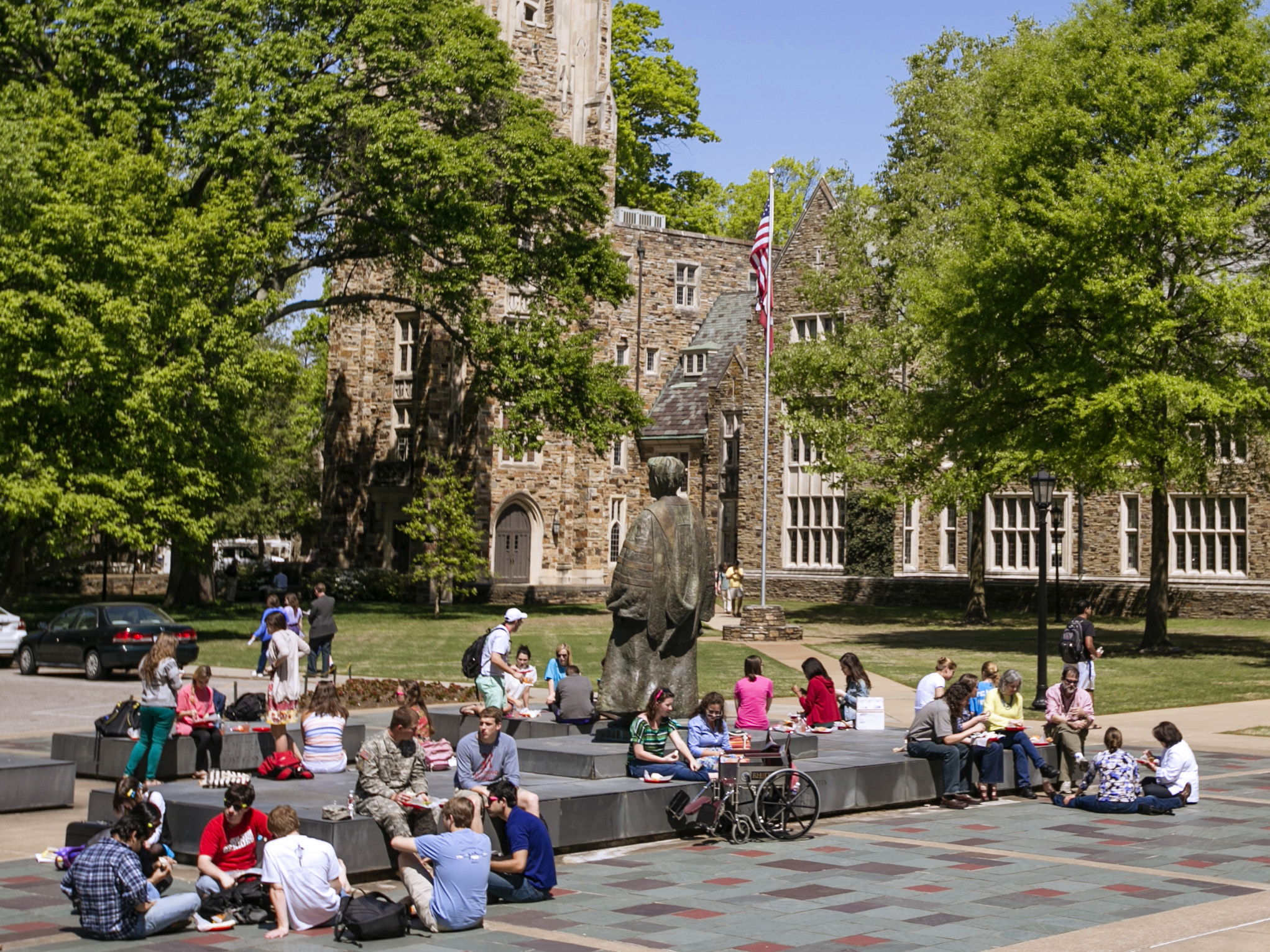 Many students sitting outside around the Diehl statue