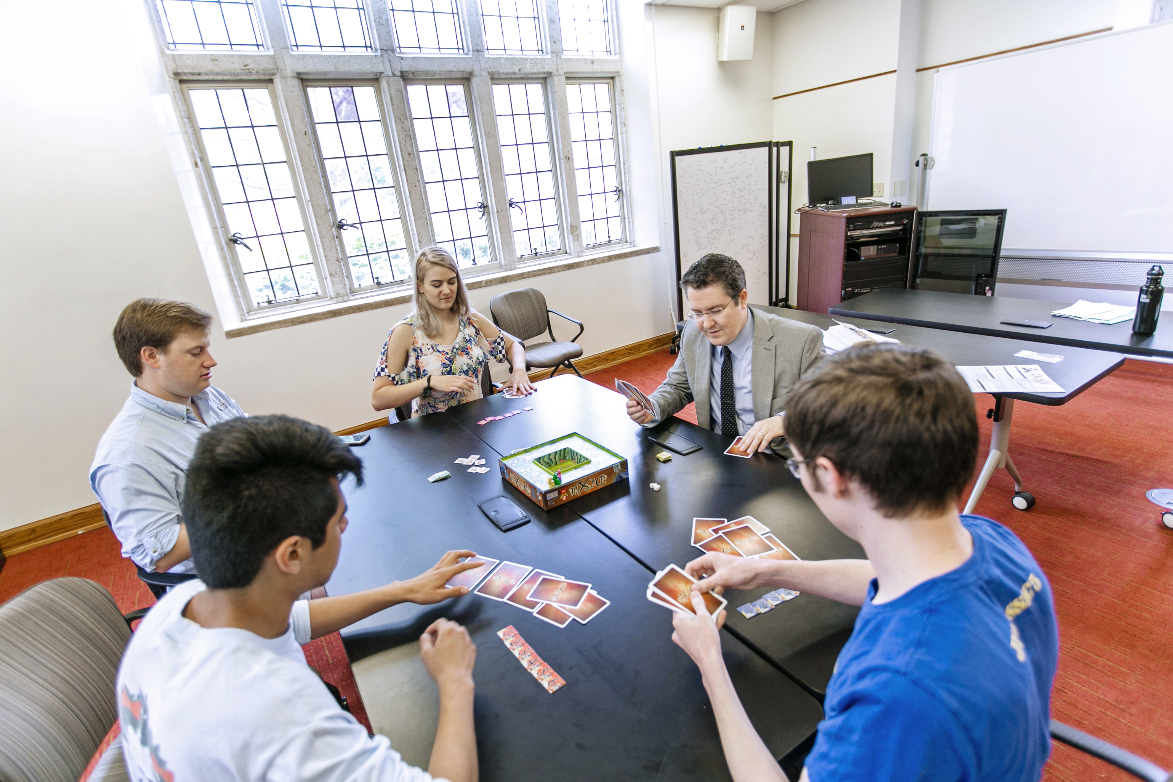 students gather around a table