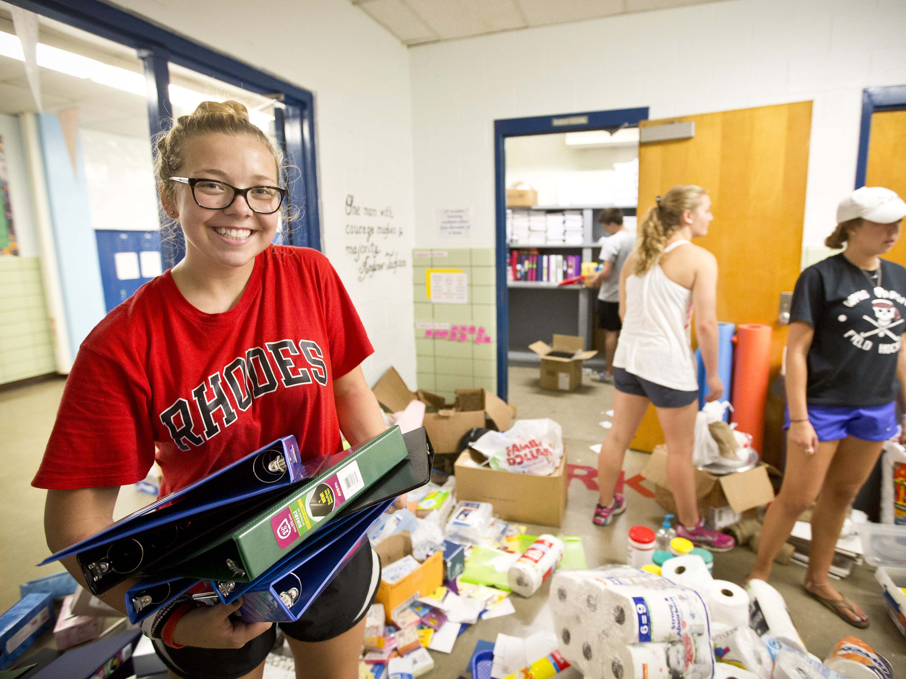 a young woman helps hand out supplies