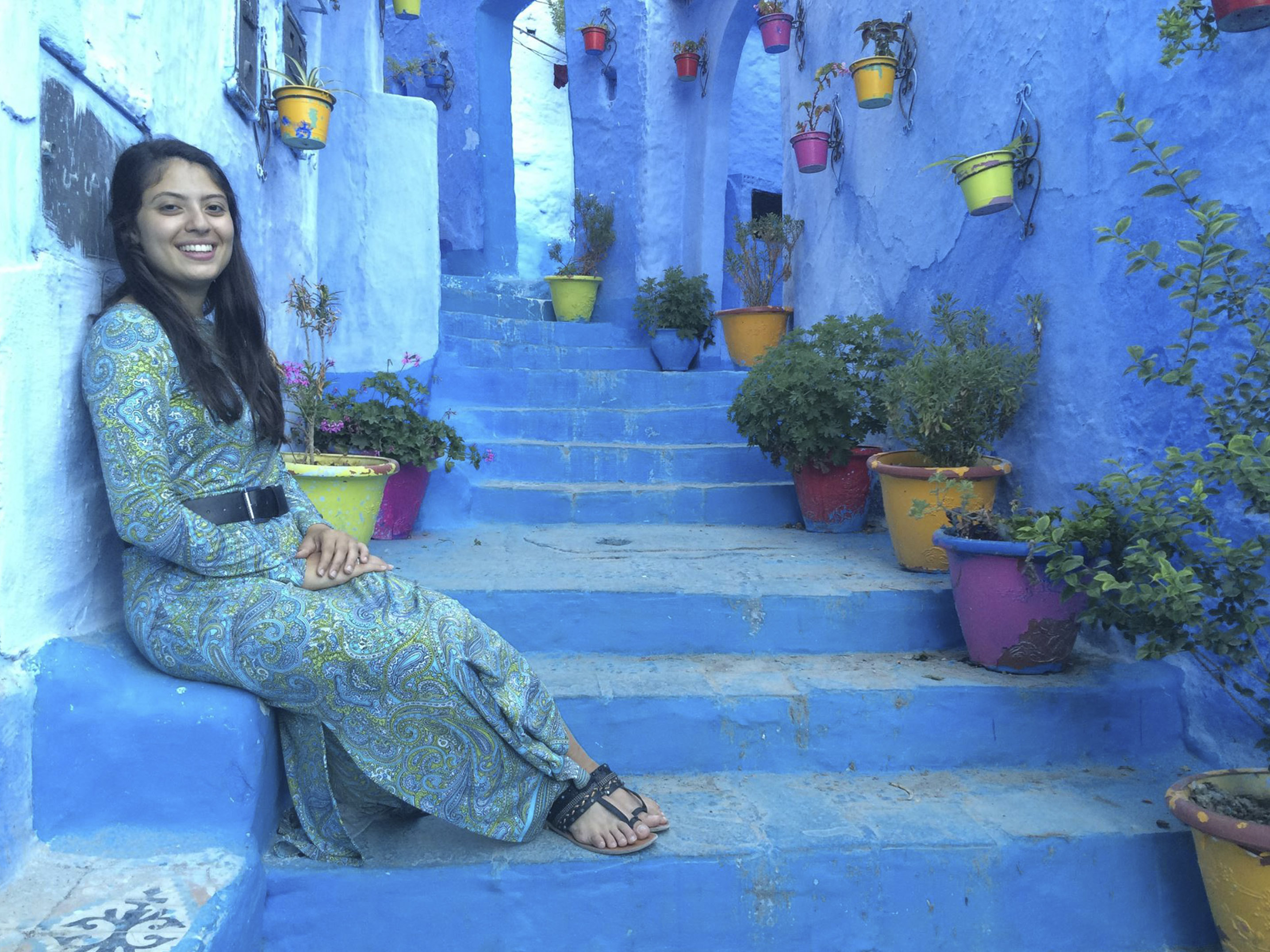 a student sitting on some steps in a foreign land