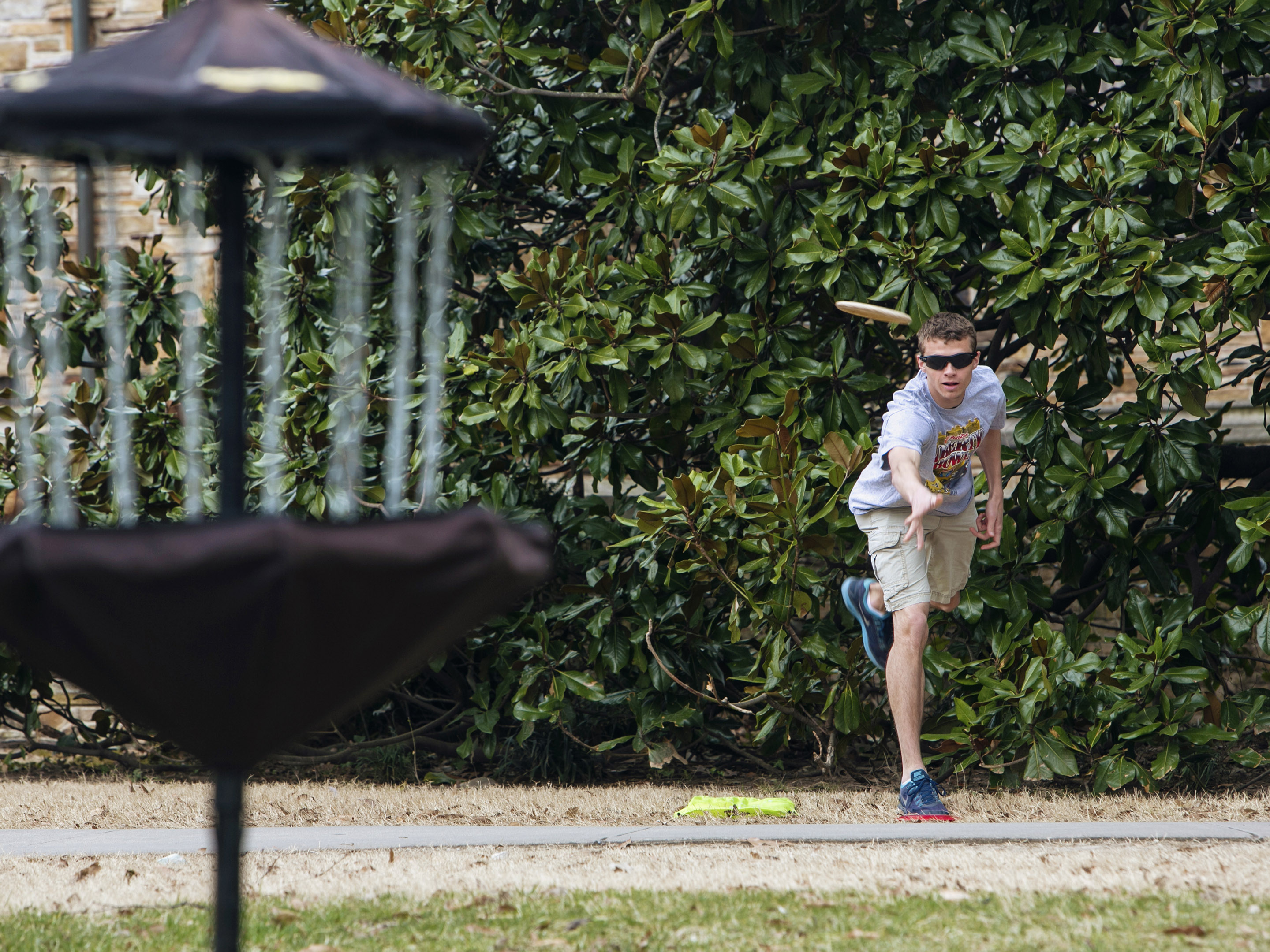 a student throws a frisbee