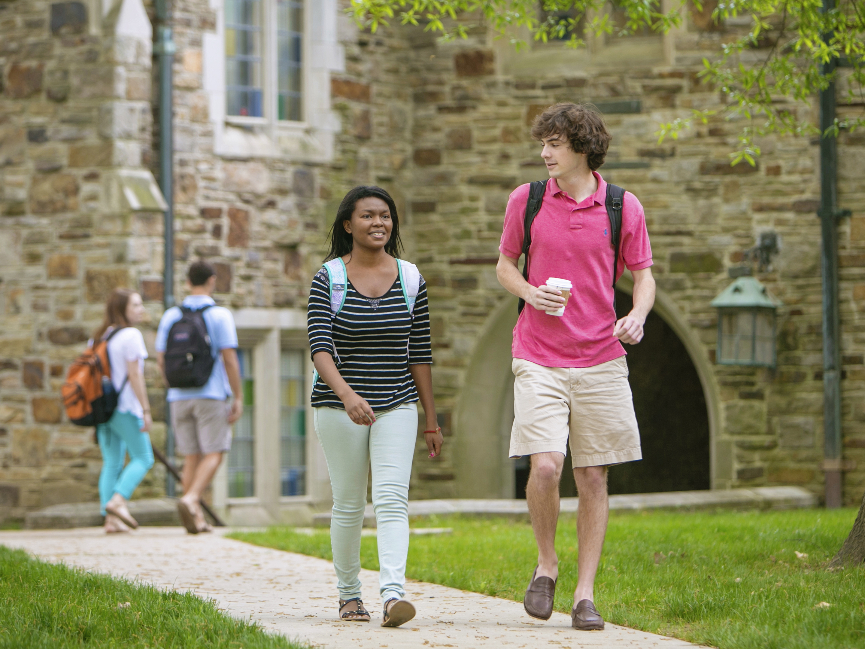 Students walking and talking on a sidewalk
