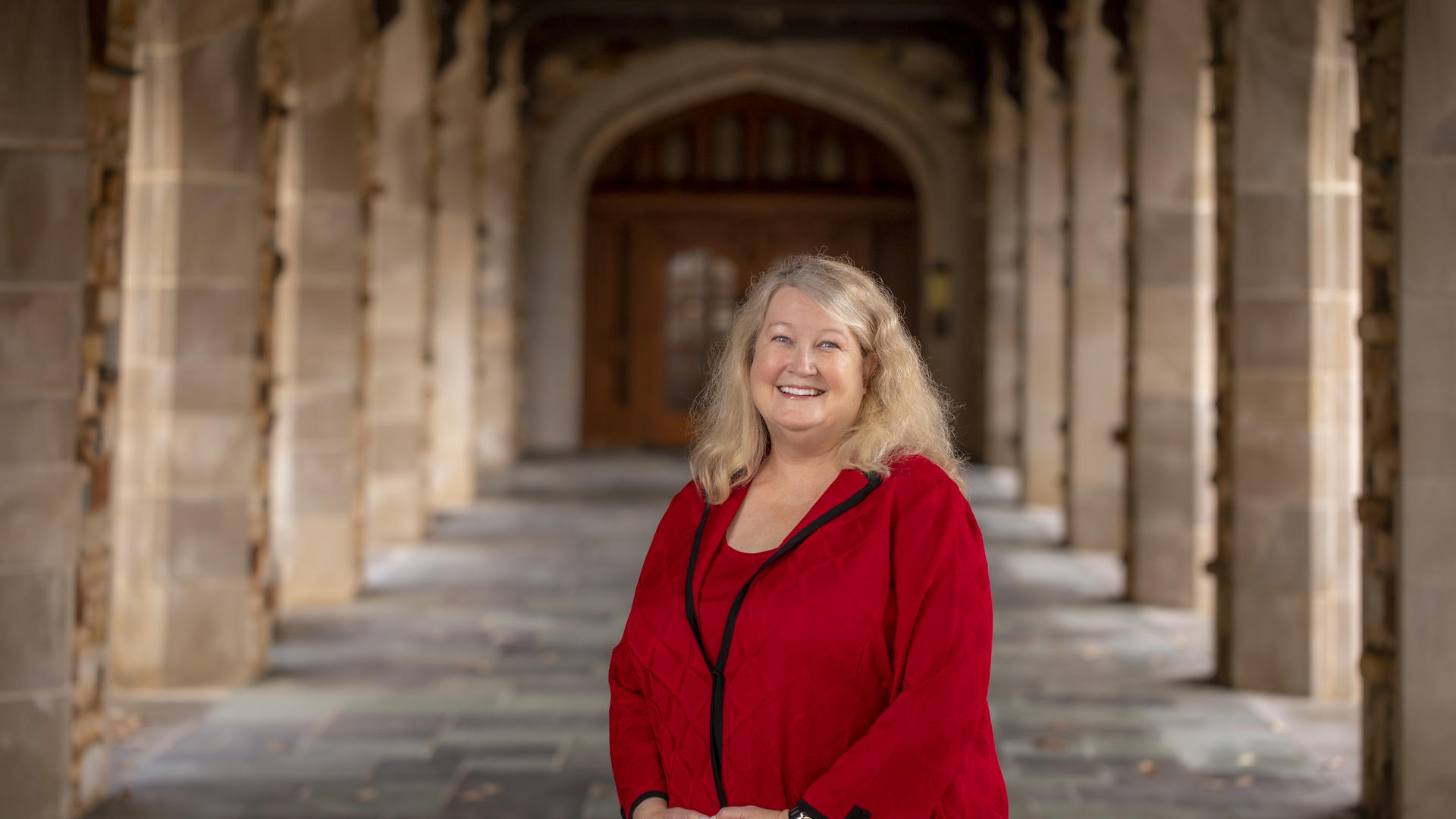 President Elect Jennifer M. Collins standing in the cloister of the Paul Barrett Jr. Library.