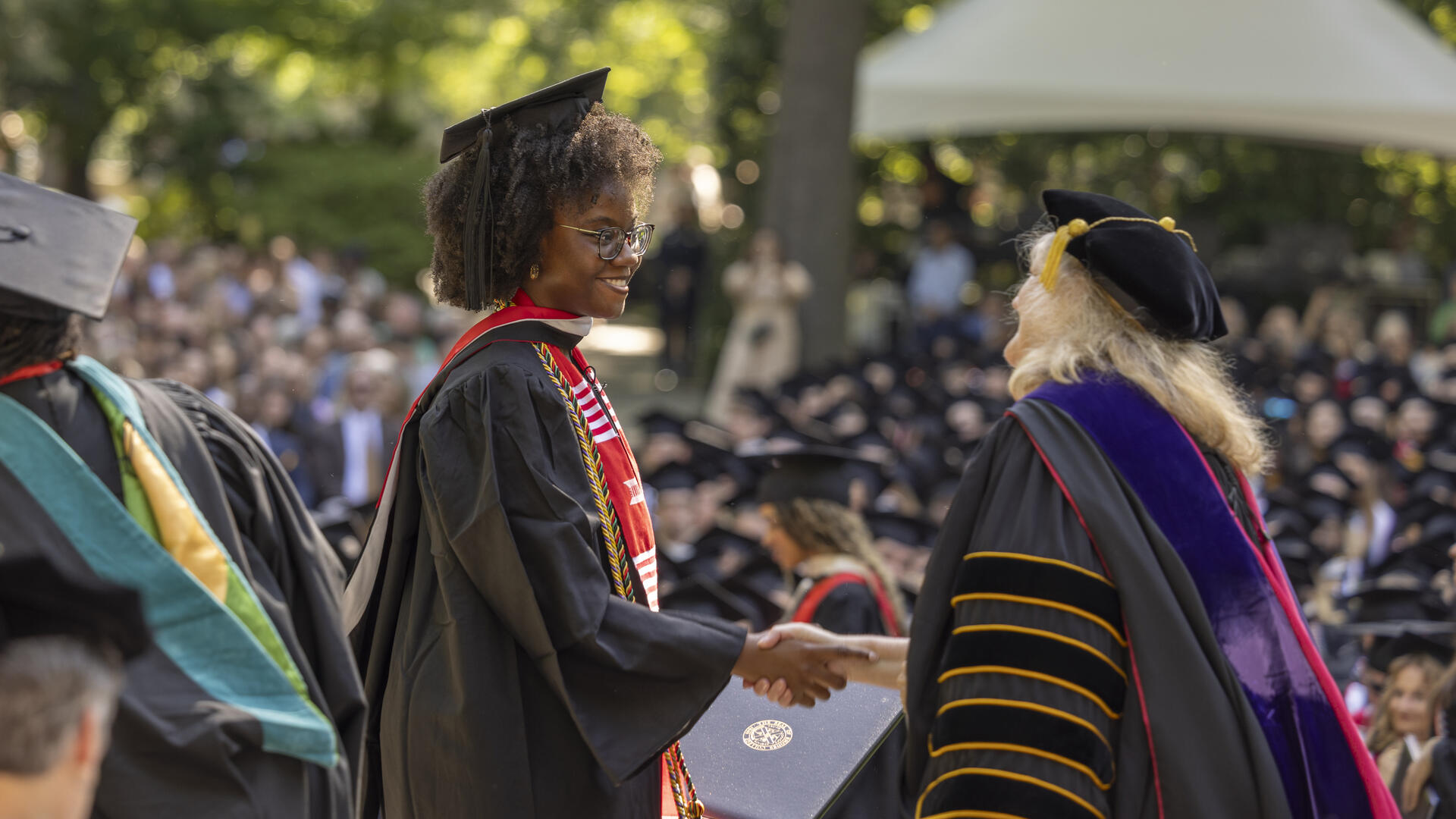 Student Shaking hands with Jennifer Collins