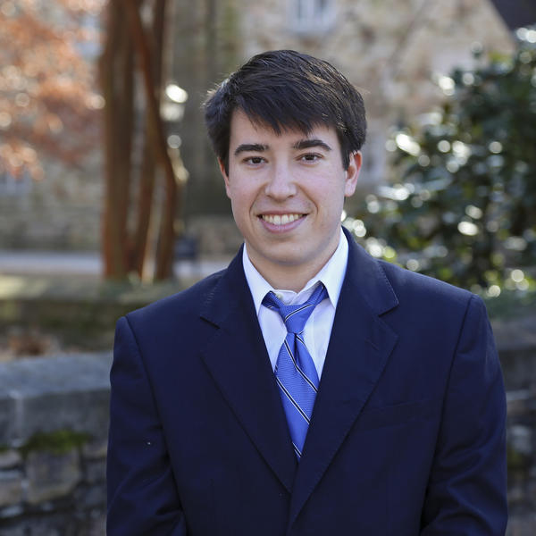 Portrait of Ben Tracy outside by a tree