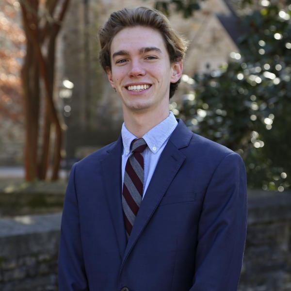 Portrait of Zach Thornton outside by a tree