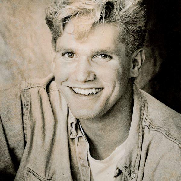 A sepia image of a young man with blonde hair