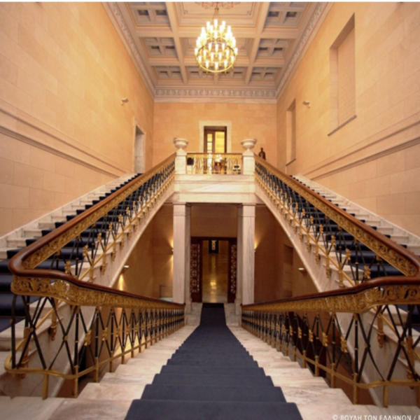 A photo of a hall with two staircases going up each side