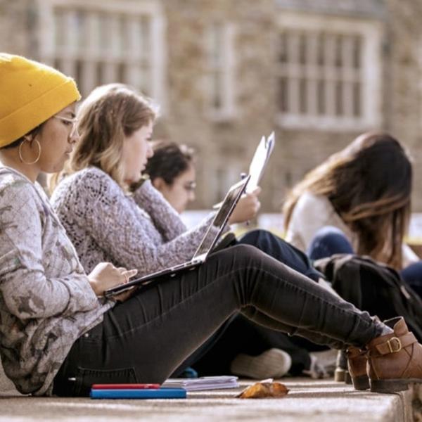 Students sit together in the amphitheatre.