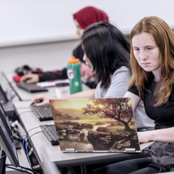 Students paint together in an oil class.