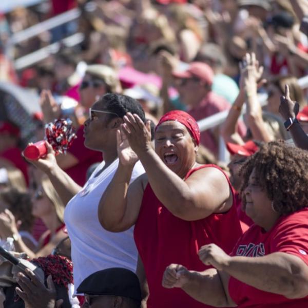 Fans cheer in the football stadium on Family Weekend.