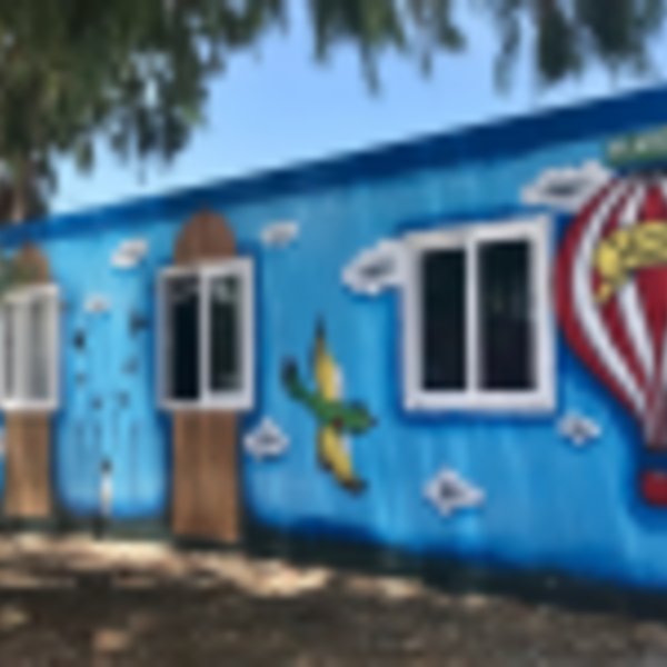 A mostly blue mural featuring a hot air balloon