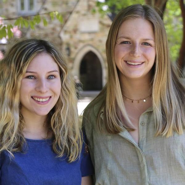 Two women standing together on the Rhodes campus