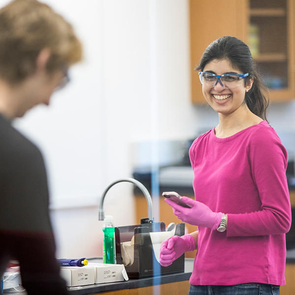student with safety glasses in a lab