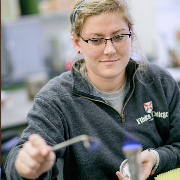 a student with a bunsen burner