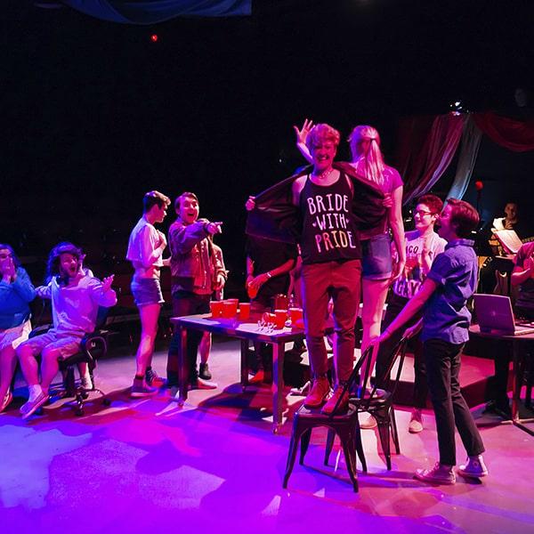 a cast of students on stage