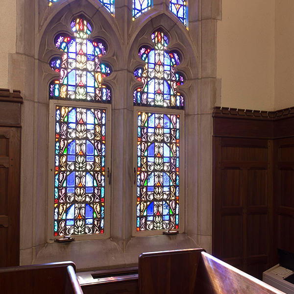 stained glass windows and a church pew