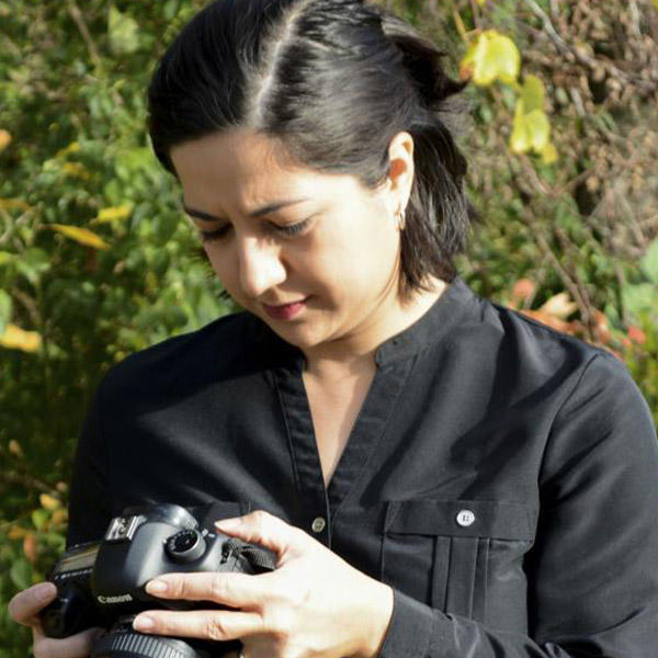 a female with dark hair holding a camera
