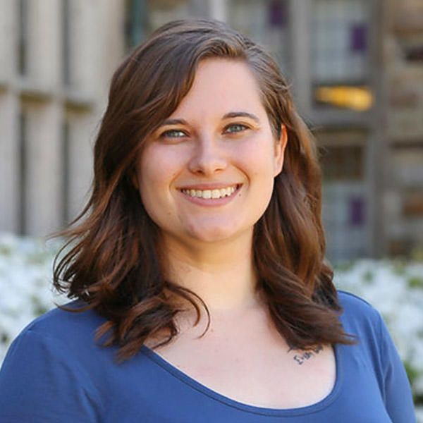 a girl with shoulder-length brown hair smiles at the camera