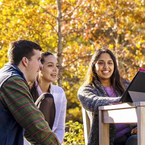 Students gathered around an iPad