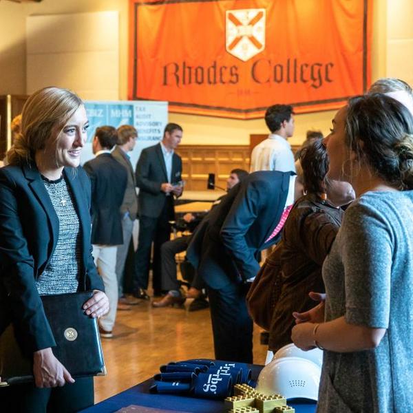 Two young women discuss career opportunities.