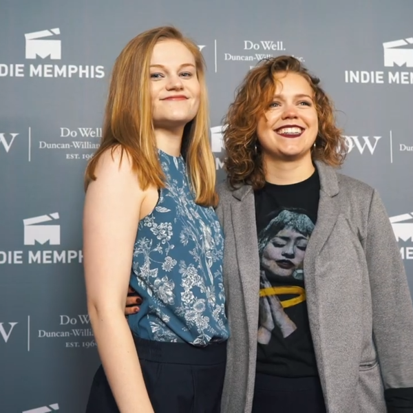 Two young women take to the red carpet at a film festival.