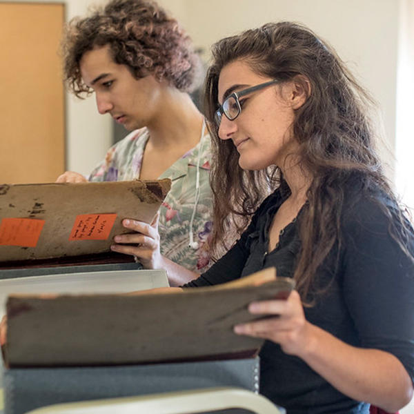 two students look at manuscrips