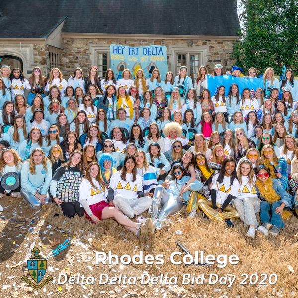 a large group of young women in front of a sign that says Tri Delta