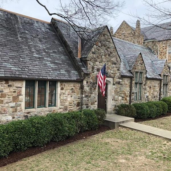 a stone building with an American Flag