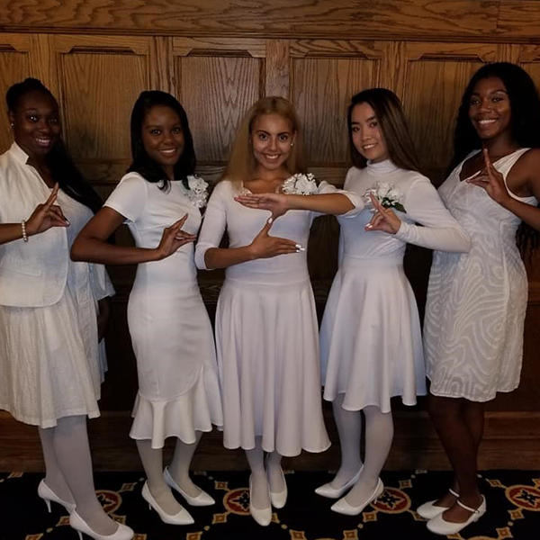five African American women in white dresses